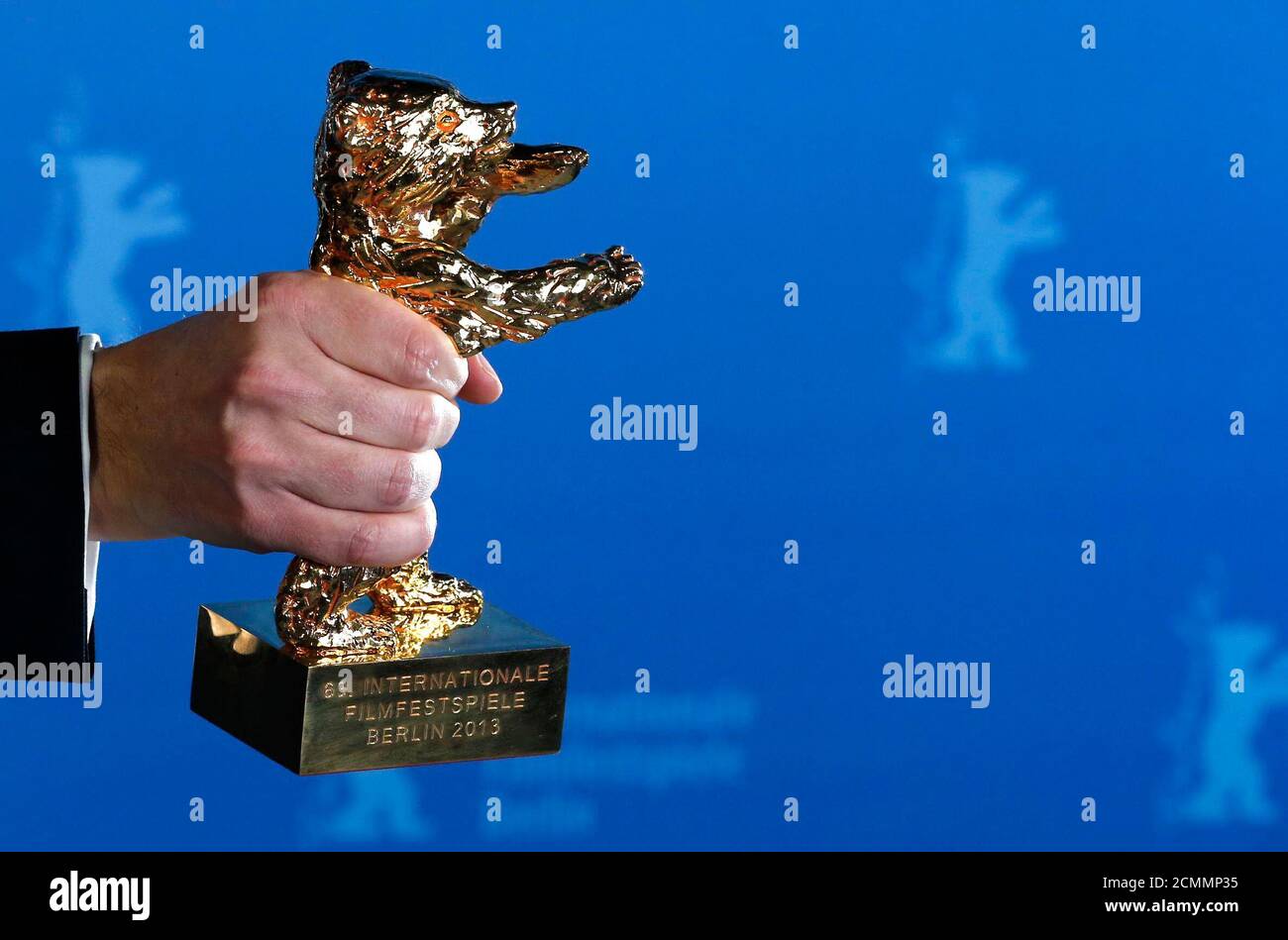 The Golden Bear award for the Best Film is held by winner Calin Peter Netzer for the film 'Pozi?ia Copilului' (Child's Pose) at the 63rd Berlinale International Film Festival in Berlin February 16, 2013. REUTERS/Thomas Peter (GERMANY  - Tags: ENTERTAINMENT) Stock Photo