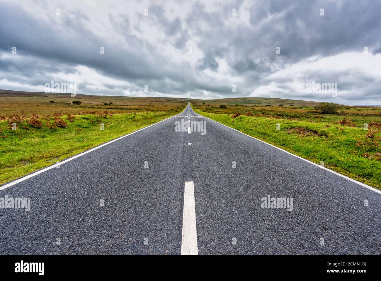 A straight road heading into the distance and vanishing point on Cefn Bryn a ridge with commoin