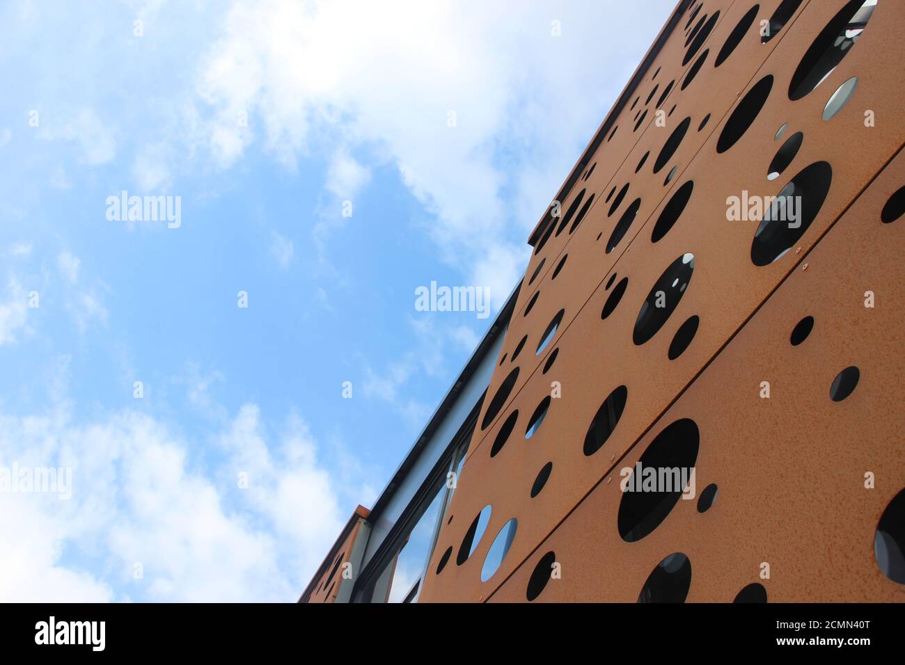 Modern building facade with rusty wall under blue sky. Copy space Stock ...