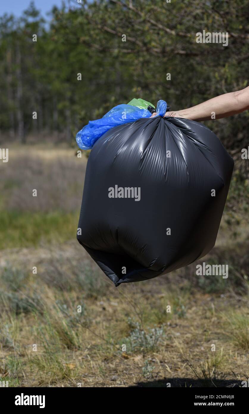 The big black plastic bags with garbage waste in forest Stock Photo - Alamy