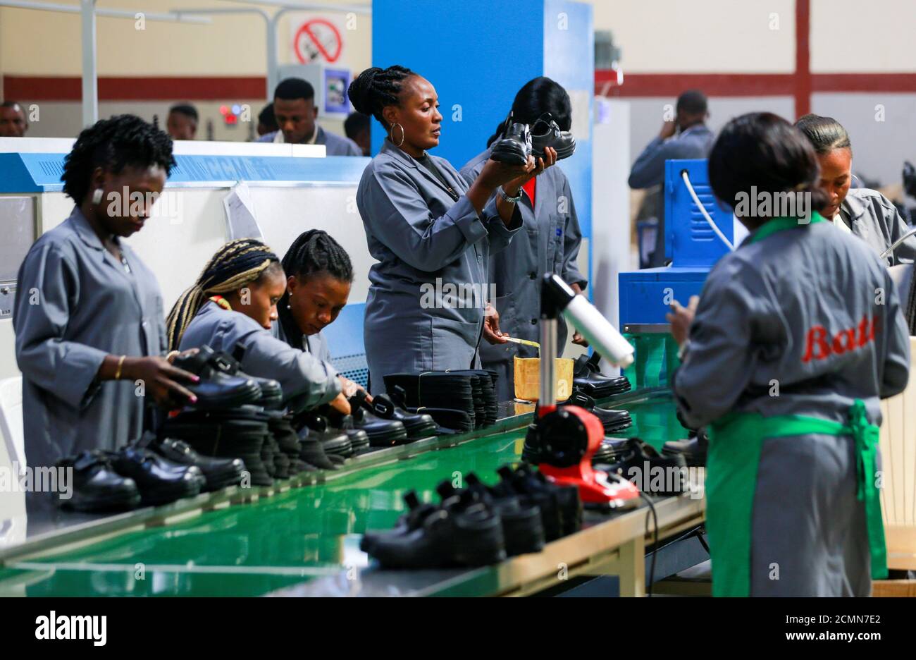 Women workers inspect shoes at a Bata shoe factory in Abuja, Nigeria January 13, 2020. Picture taken January 13, 2020. REUTERS/Afolabi Sotunde Stock Photo