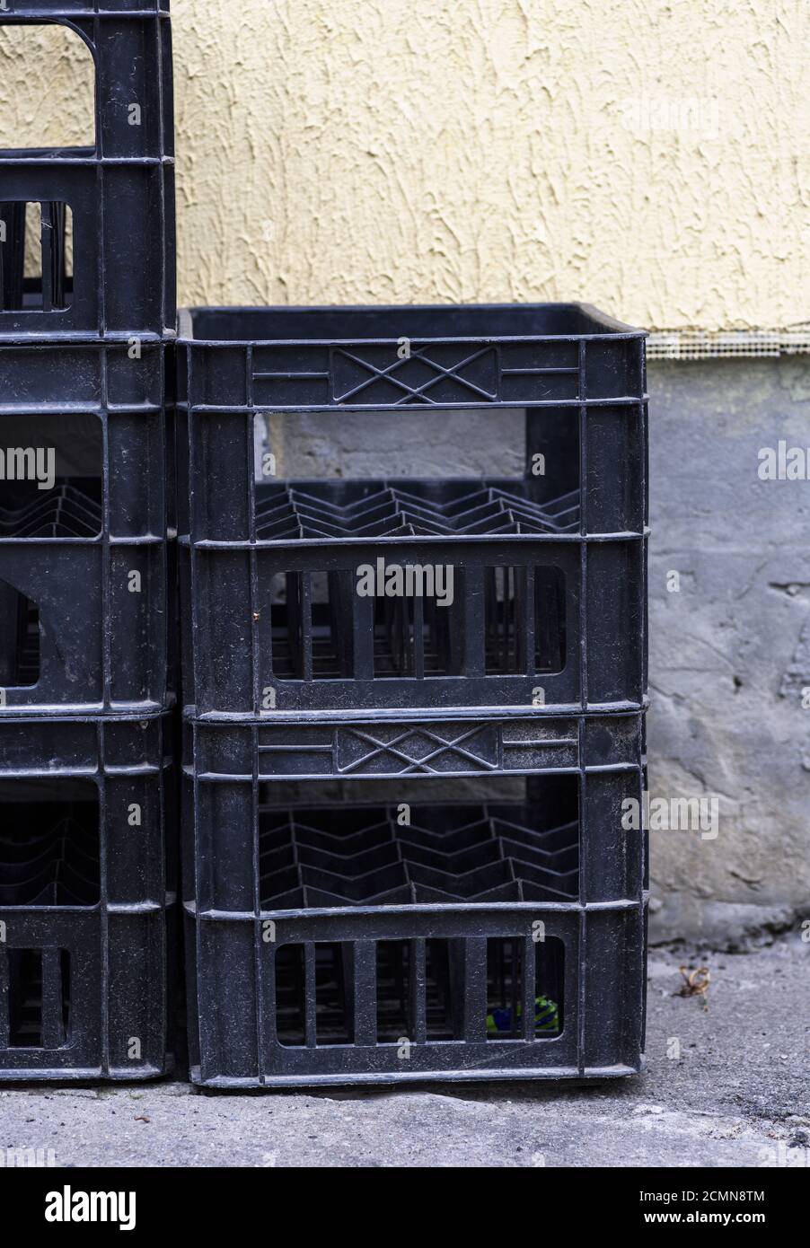 stack of empty black plastic crates Stock Photo