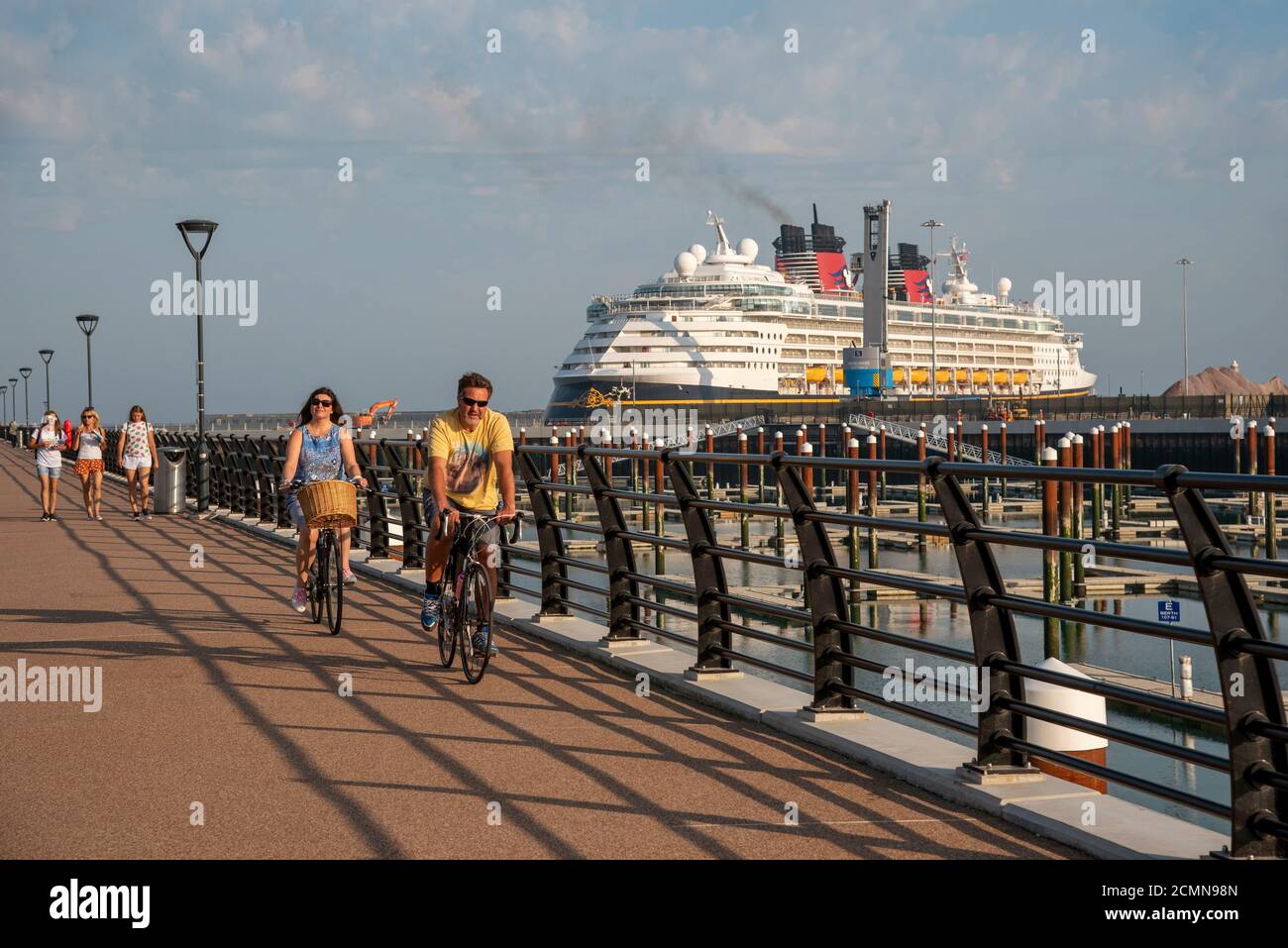 Western Docks, Dover, Kent, England, UK. 2020. Cyclists on the new pier  a part of the revival project within the Western Docks area, Dover. Stock Photo