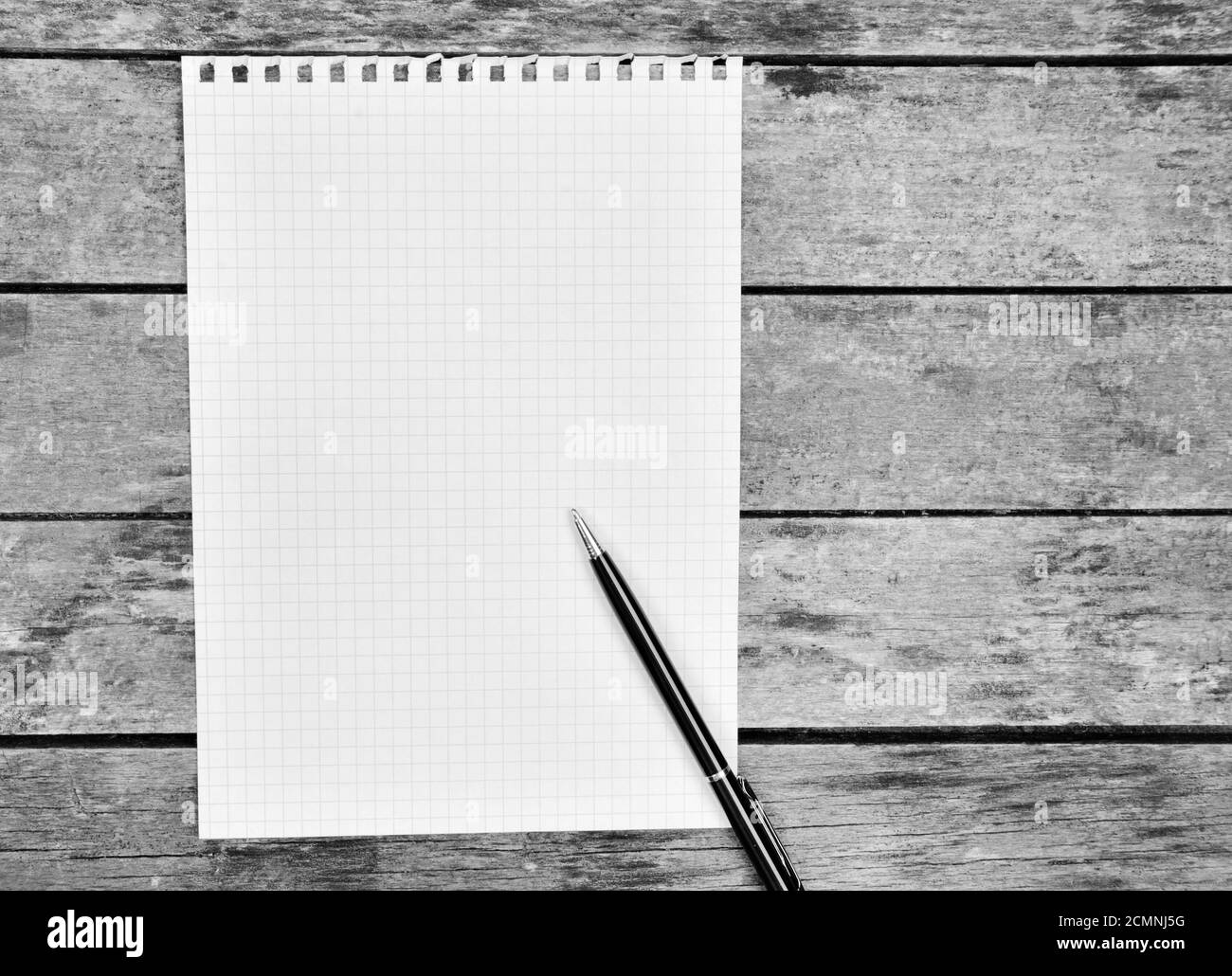 Empty paper with pen on an old wooden table Stock Photo