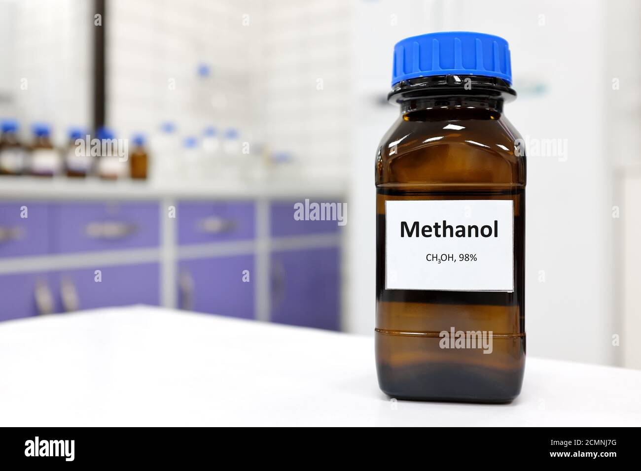 Selective focus of toxic methanol or methyl alcohol in glass bottle inside a laboratory. Stock Photo