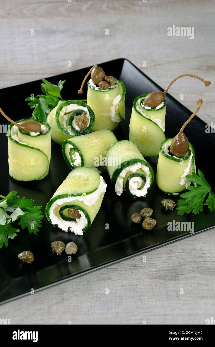 Cucumber rolls with ricotta filling and capers.   These rolls with the size of a bite -is a great op Stock Photo