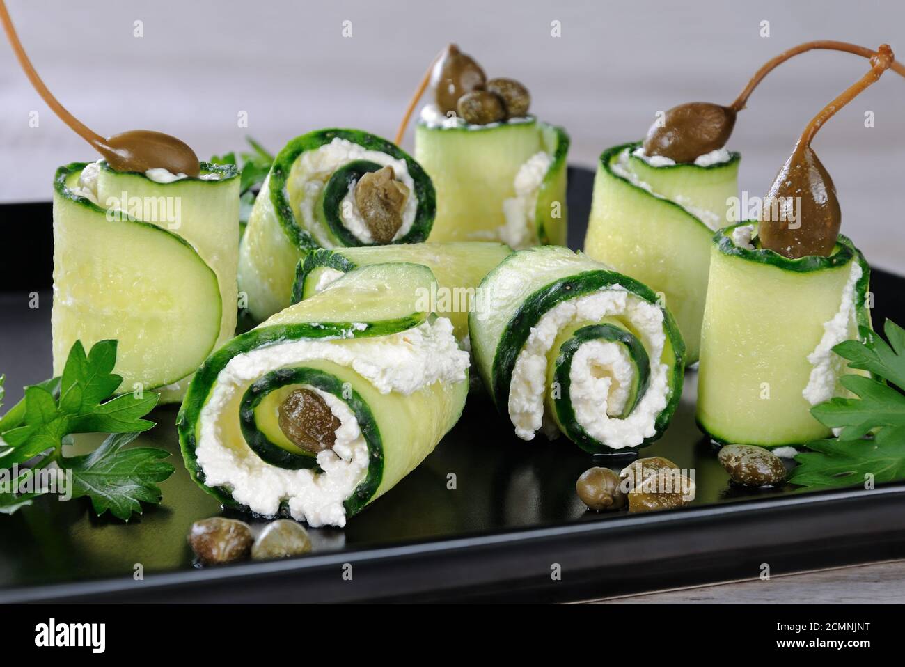 Cucumber rolls with ricotta filling and capers.   These rolls with the size of a bite -is a great op Stock Photo