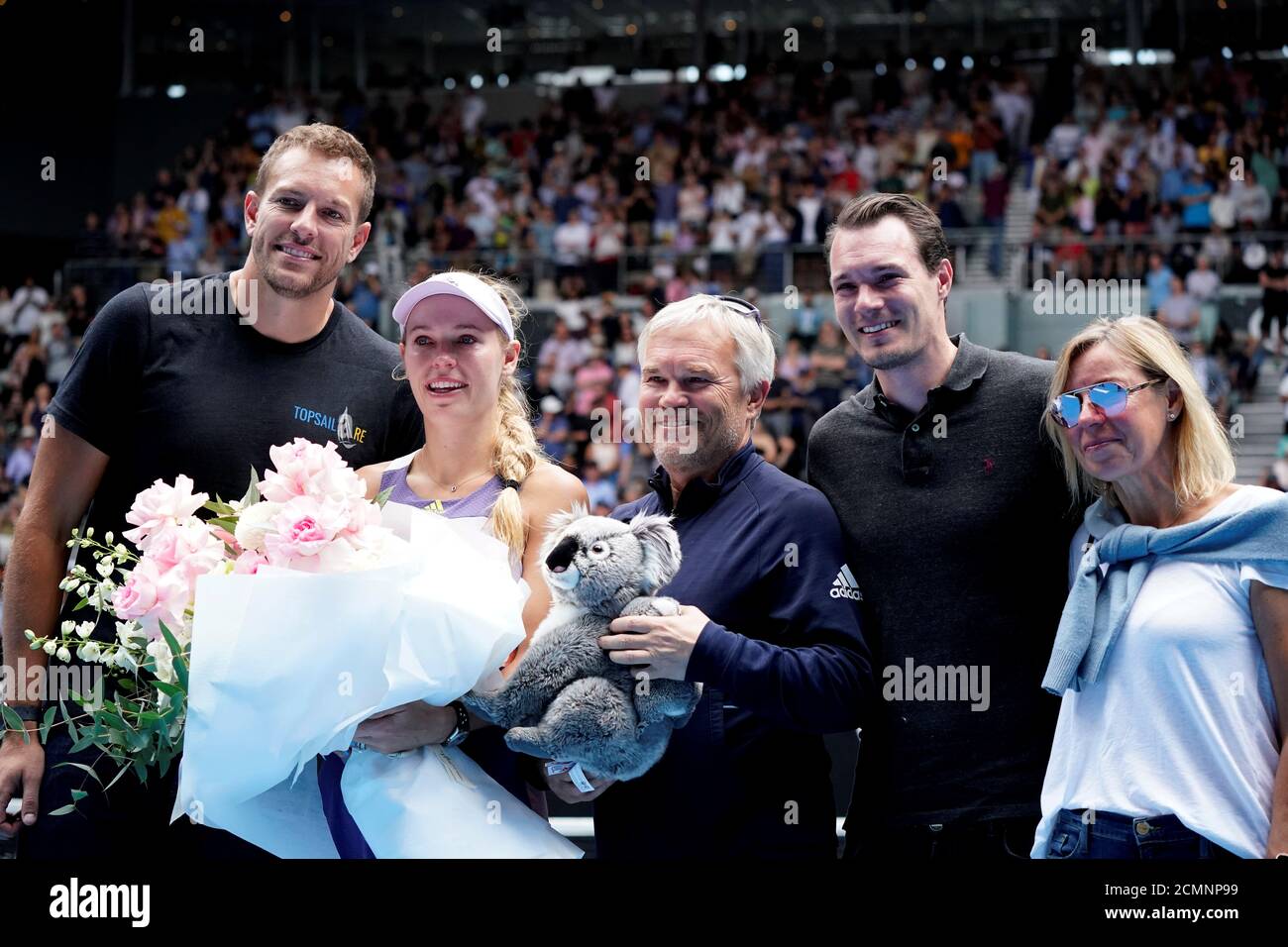 Tennis - Australian Open - Third Round - Melbourne Park, Melbourne,  Australia - January 24, 2020 - Denmark's Caroline Wozniacki poses for  pictures with her husband David Lee, coach and father Piotr
