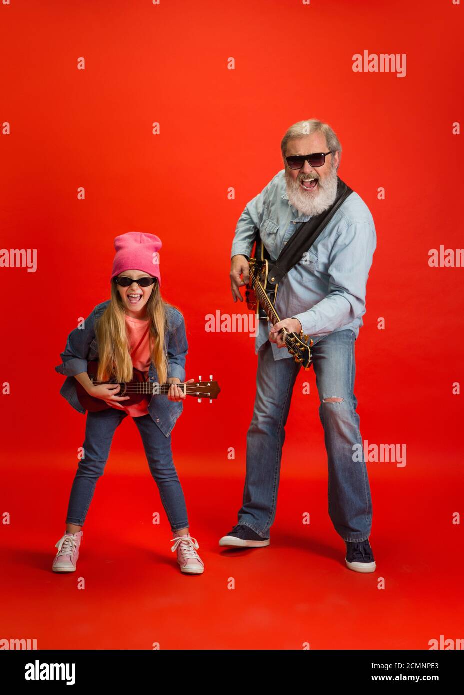 Music Band Senior Man Spending Happy Time With Granddaughter On Red Background Joyful Elderly Lifestyle Family Childhood Tech Concept Enjoying Modern Music Technologies Copyspace Stock Photo Alamy