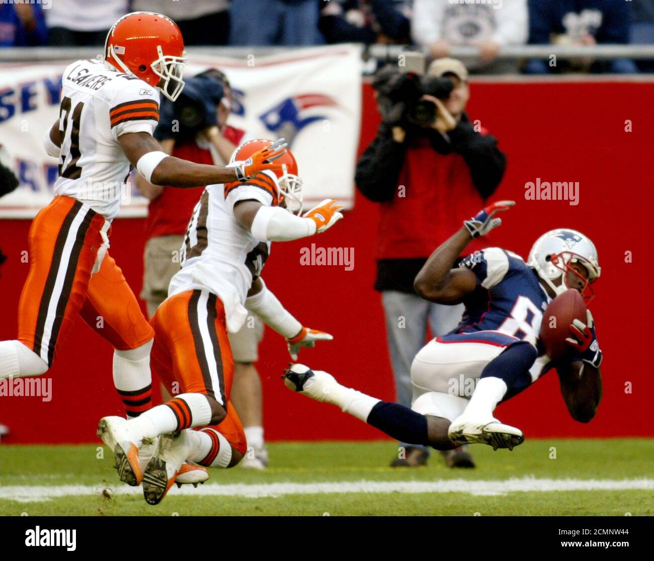 New England Patriots' wide receiver Bethel Johnson (R) pulls in a 45-yard  pass in front of Cleveland Browns' defensive backs Earl Little (L) and  Lewis Sanders (C), in the first quarter in