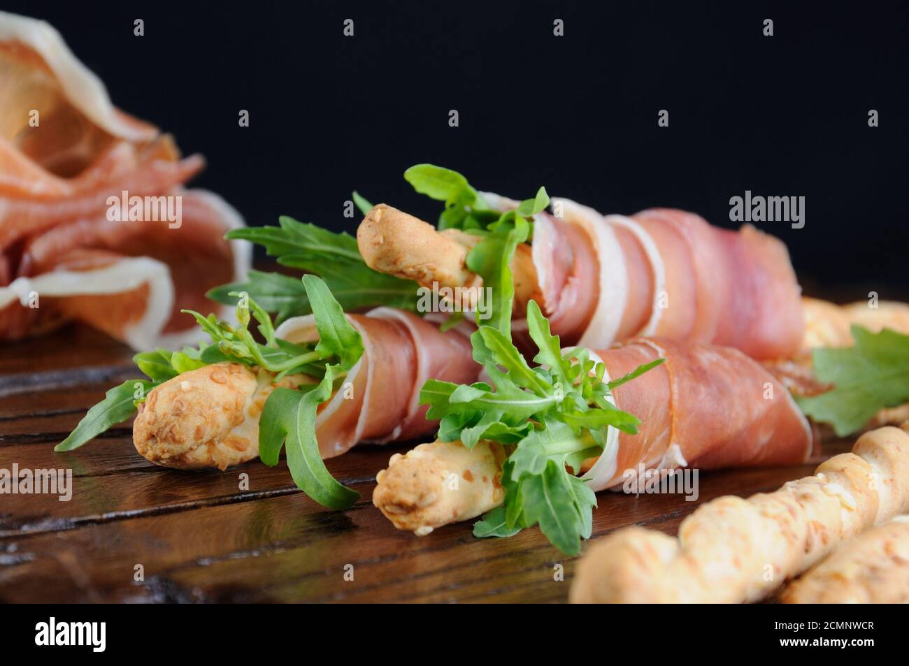 Grissini bread sticks with Parmesan, wrapped with a piece of