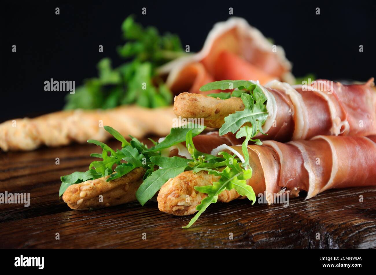 Grissini bread sticks with Parmesan, wrapped with a piece of