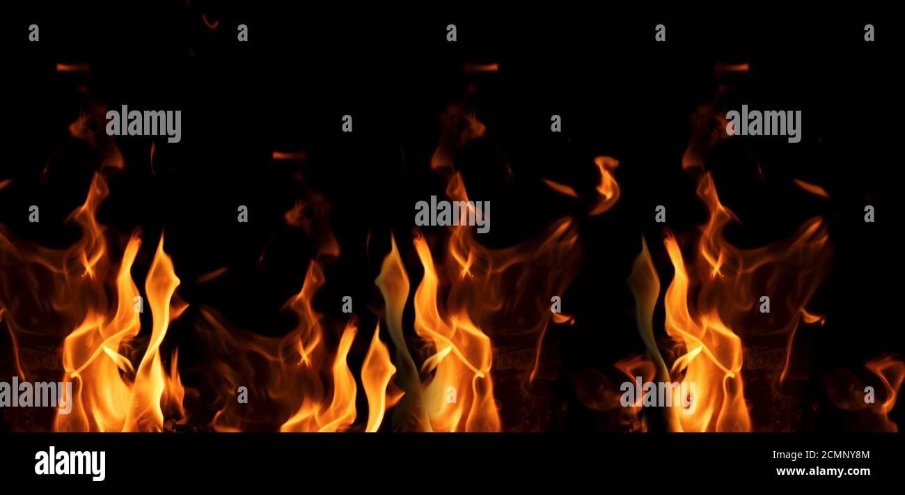 bright orange and yellow flames on a black background Stock Photo - Alamy