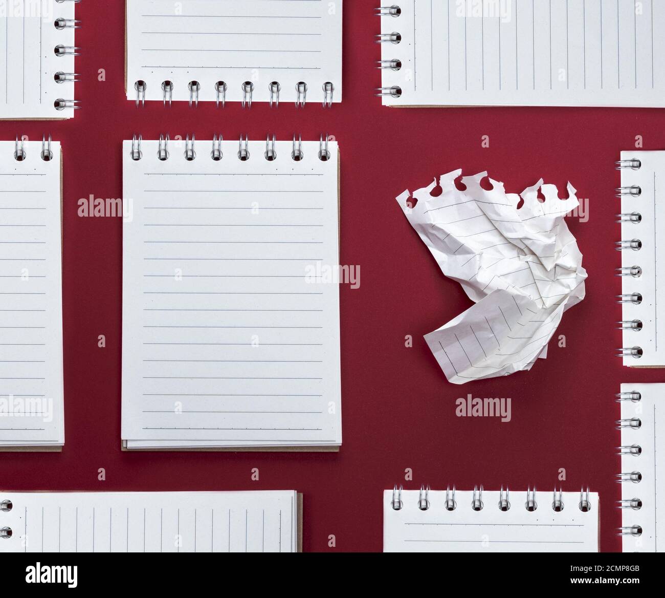 abstract red background with many notebooks with blank sheets in line Stock Photo