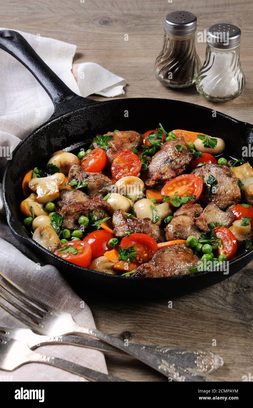 Fried chicken liver with vegetable side dish of tomatoes, carrots