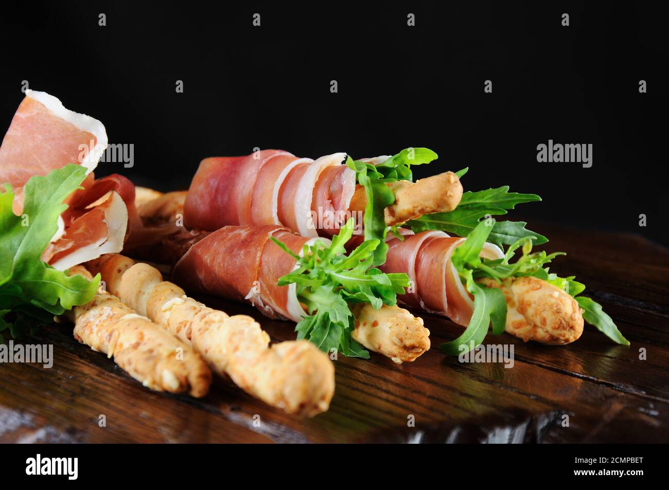 Grissini bread sticks with Parmesan, wrapped with a piece of