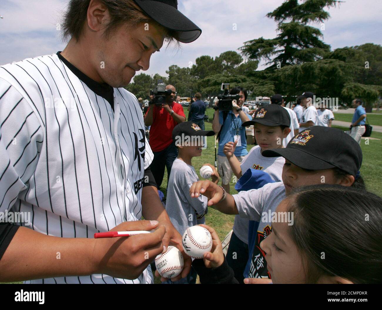Japan Samurai Bears outfielder Kazuhiro Kono, who played baseball in high school with New York Yankees slugger Hideki Matsui, signs autographs during the Bears baseball clinic in Los Angeles, May 17, 2005. The Samurai Bears will be the first all Japanese team to participate in a U.S. professional sports league when they begin their 90-game season in the independent Golden Baseball League in California and Arizona. REUTERS/Lucy Nicholson   LN/HK Stock Photo