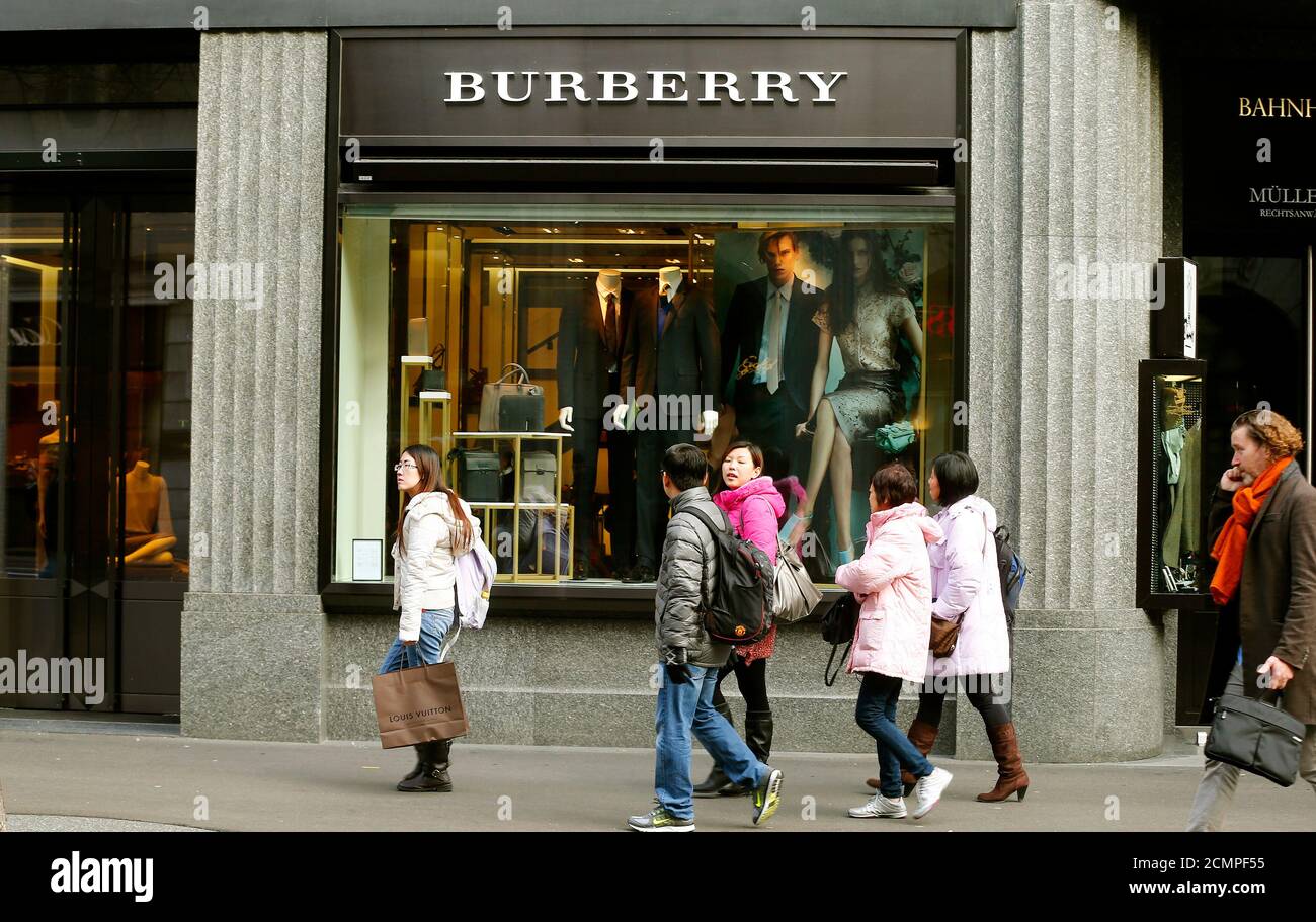 People walk past a store of British luxury brand Burberry at the  Bahnhofstrasse shopping street in Zurich January 15, 2013. Burberry posted  a 14 percent rise in underlying retail revenue in the