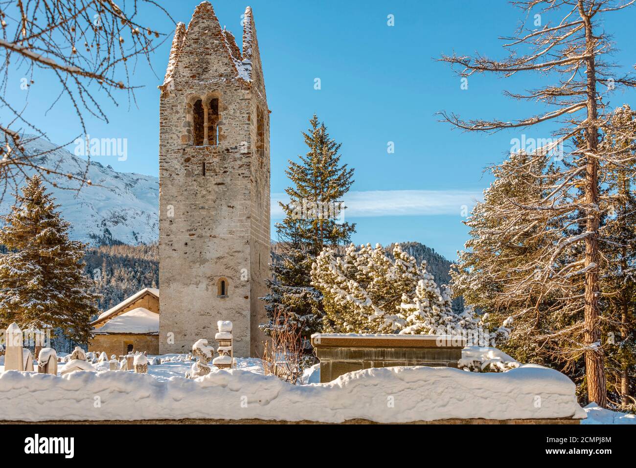 Graveyard behind the church San Gian of Celerina in winter, Engadin, Grisons, Switzerland Stock Photo