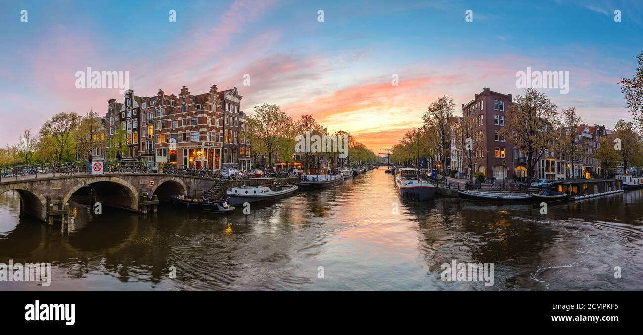 Amsterdam Netherlands, sunset panorama city skyline at canal waterfront Stock Photo