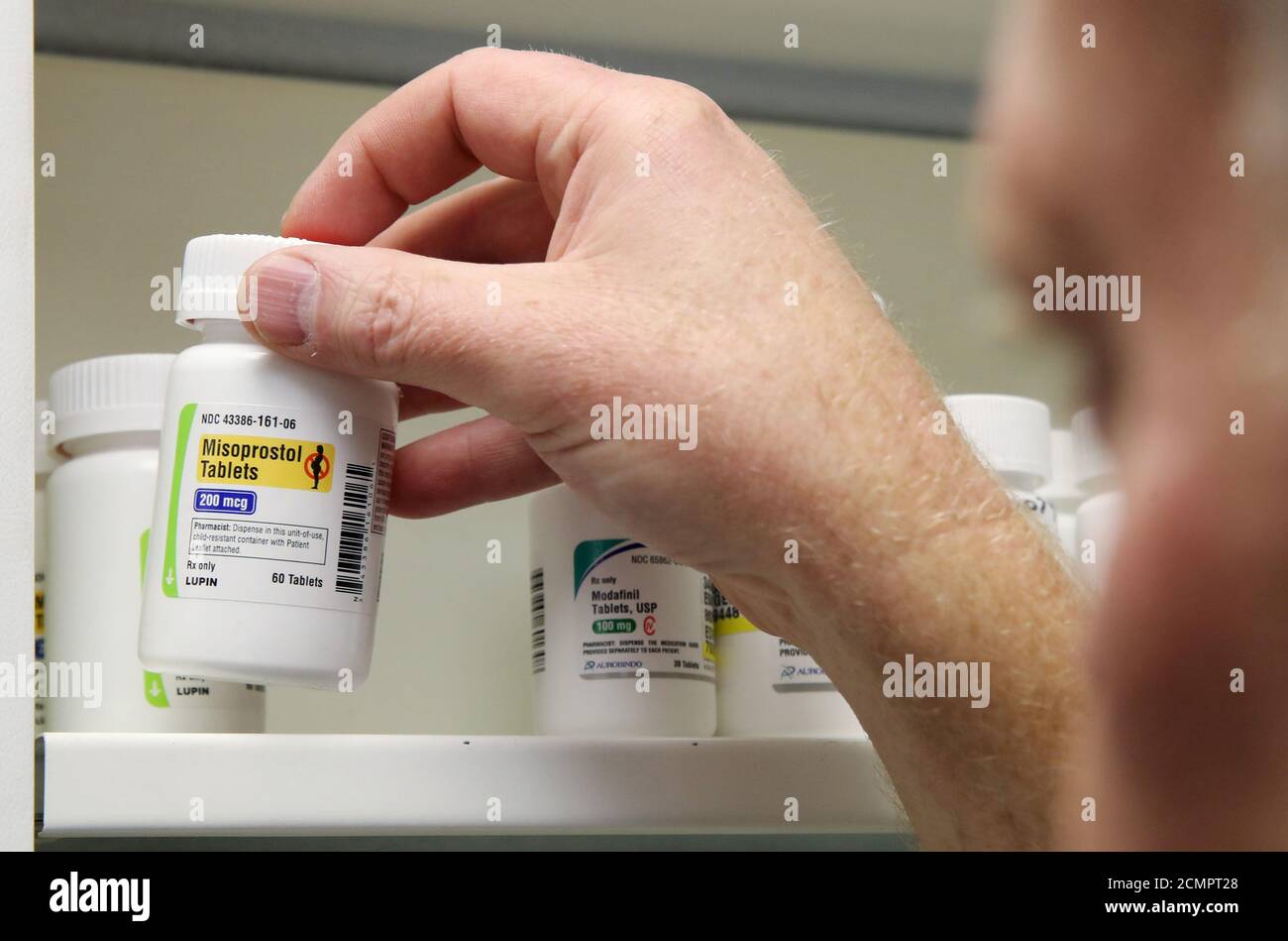 A pharmacist removes a bottle of the drug Misoprostol, made by Lupin Pharmaceuticals, from a shelf at a pharmacy in Provo, Utah, U.S., June 19, 2019. Picture taken June 19, 2019.  REUTERS/George Frey Stock Photo