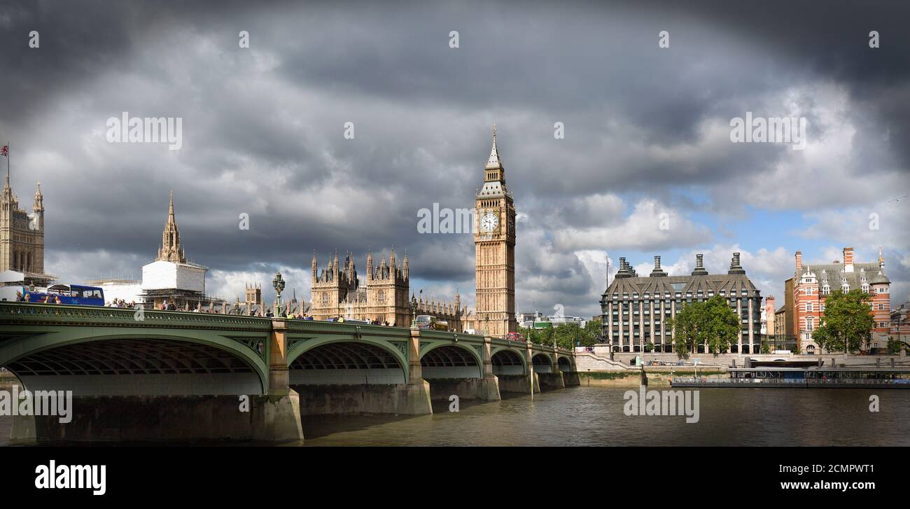Westminster Bridge and Big Ben next to the River Thames with a heavy stormy sky Stock Photo