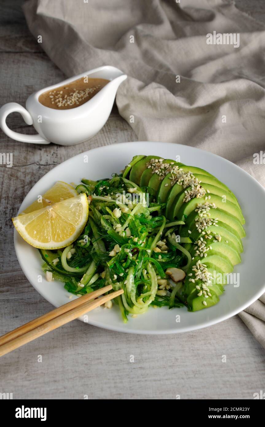 Chukka salad, cucumber noodles with avocado and peanut brown sauce in sauce boat Stock Photo