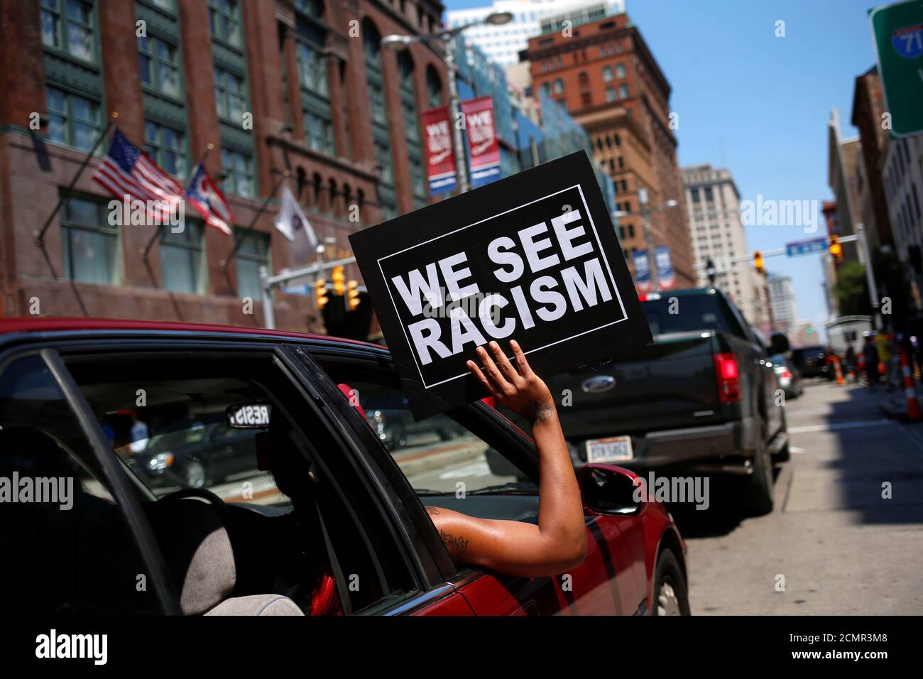 A person holds a sign outside their car window as it makes its way along Euclid avenue outside the Republican National Convention in Cleveland, Ohio, U.S. July 19, 2016. REUTERS/Shannon Stapleton Stock Photo