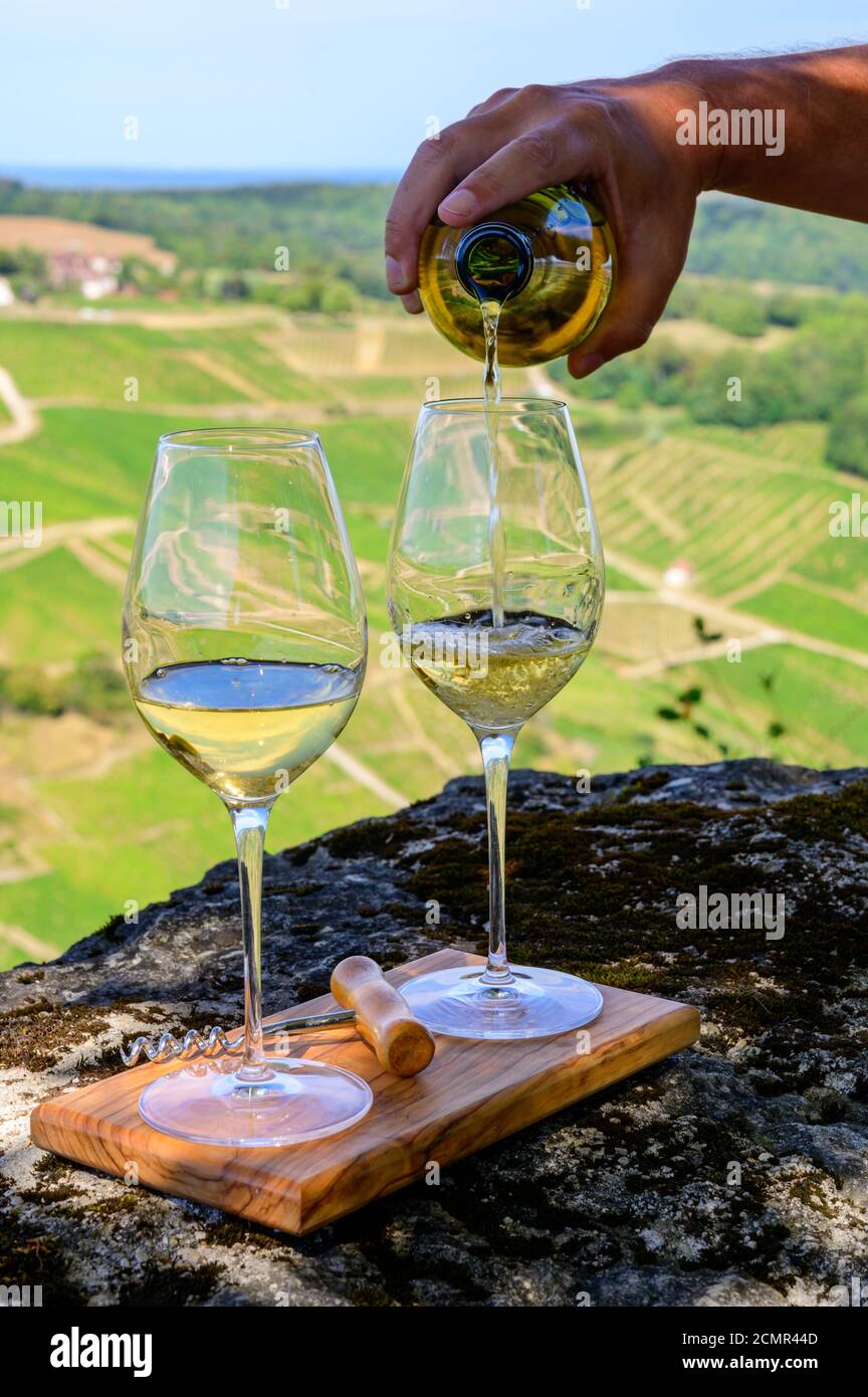 Outdoor tasting of white or jaune Jura wine on vineyards near Chateau