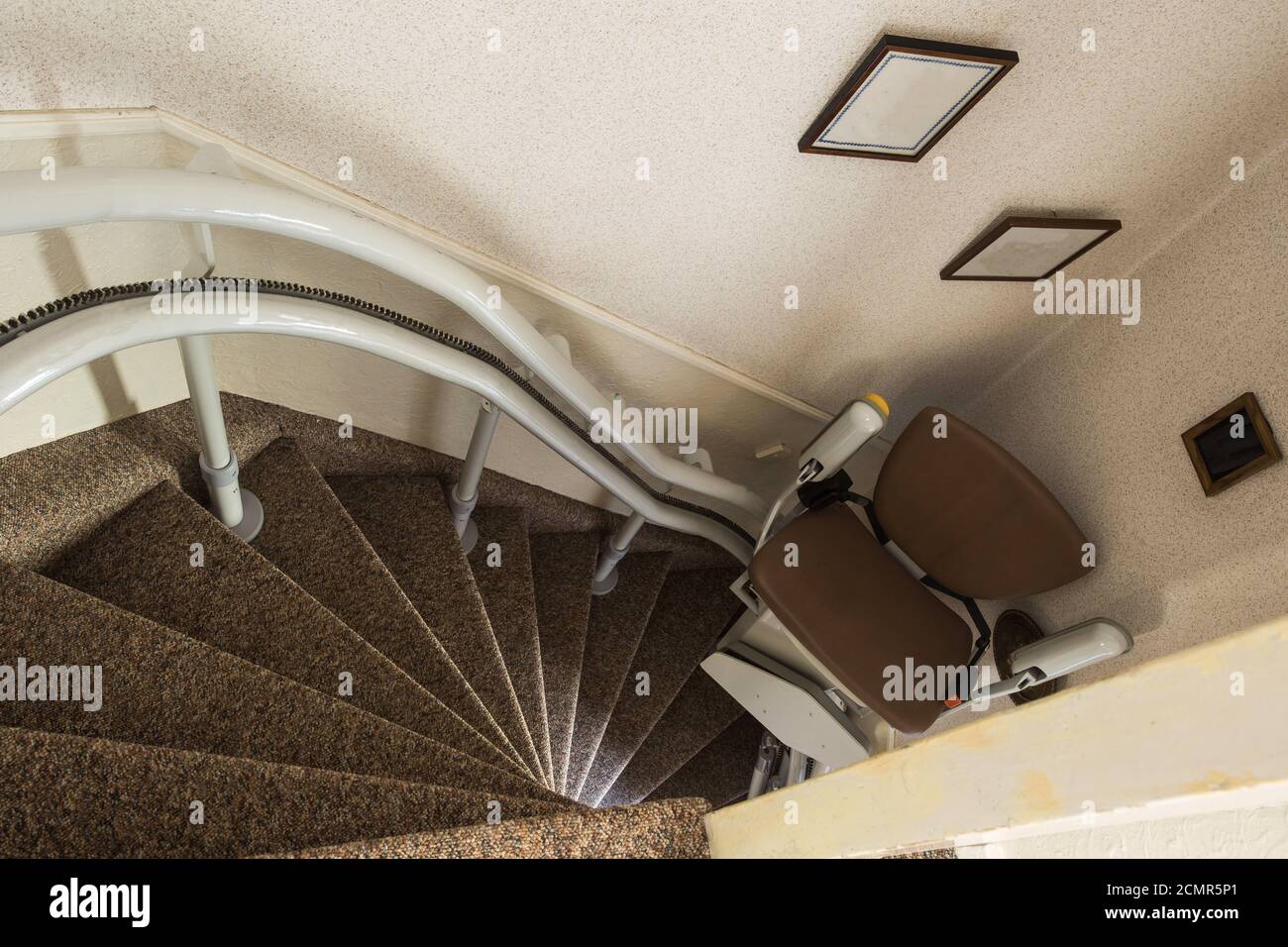 Mechanical chair lift taking disabled or aged people up and down stairs Senior, Stairlift for