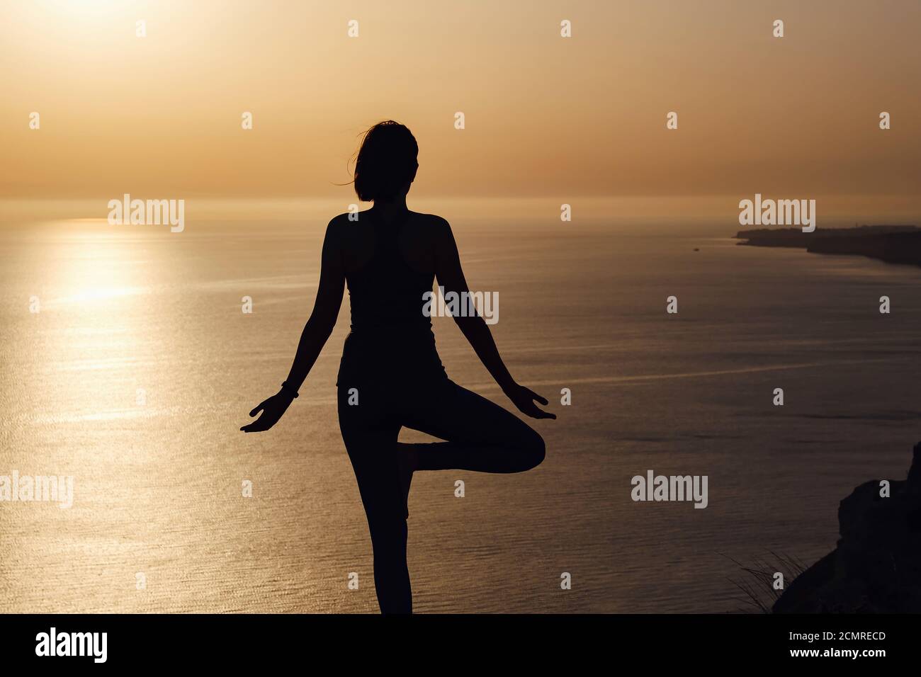 The woman with yoga posture on the mountain at sunset Silhouette of ...
