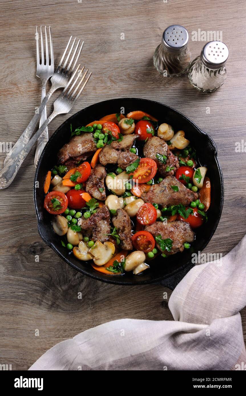 Fried chicken liver with vegetable side dish of tomatoes, carrots