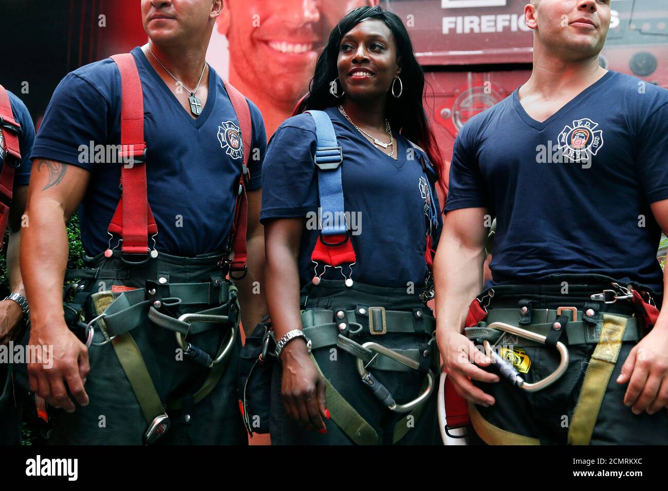 Fire Department of New York's (FDNY) firefighter Danae Mines (C), a 11-year  veteran of Engine Co. 60 in the South Bronx, stands with fellow  firefighters during a promotional signing of the FDNY