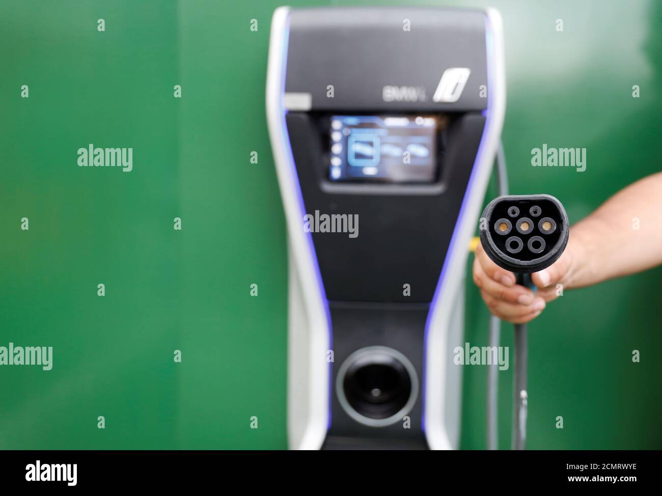 A man holds an electric car charger in a car park at a McDonald's  restaurant in Sao Paulo, Brazil, March 3, 2018. REUTERS/Nacho Doce Stock  Photo - Alamy