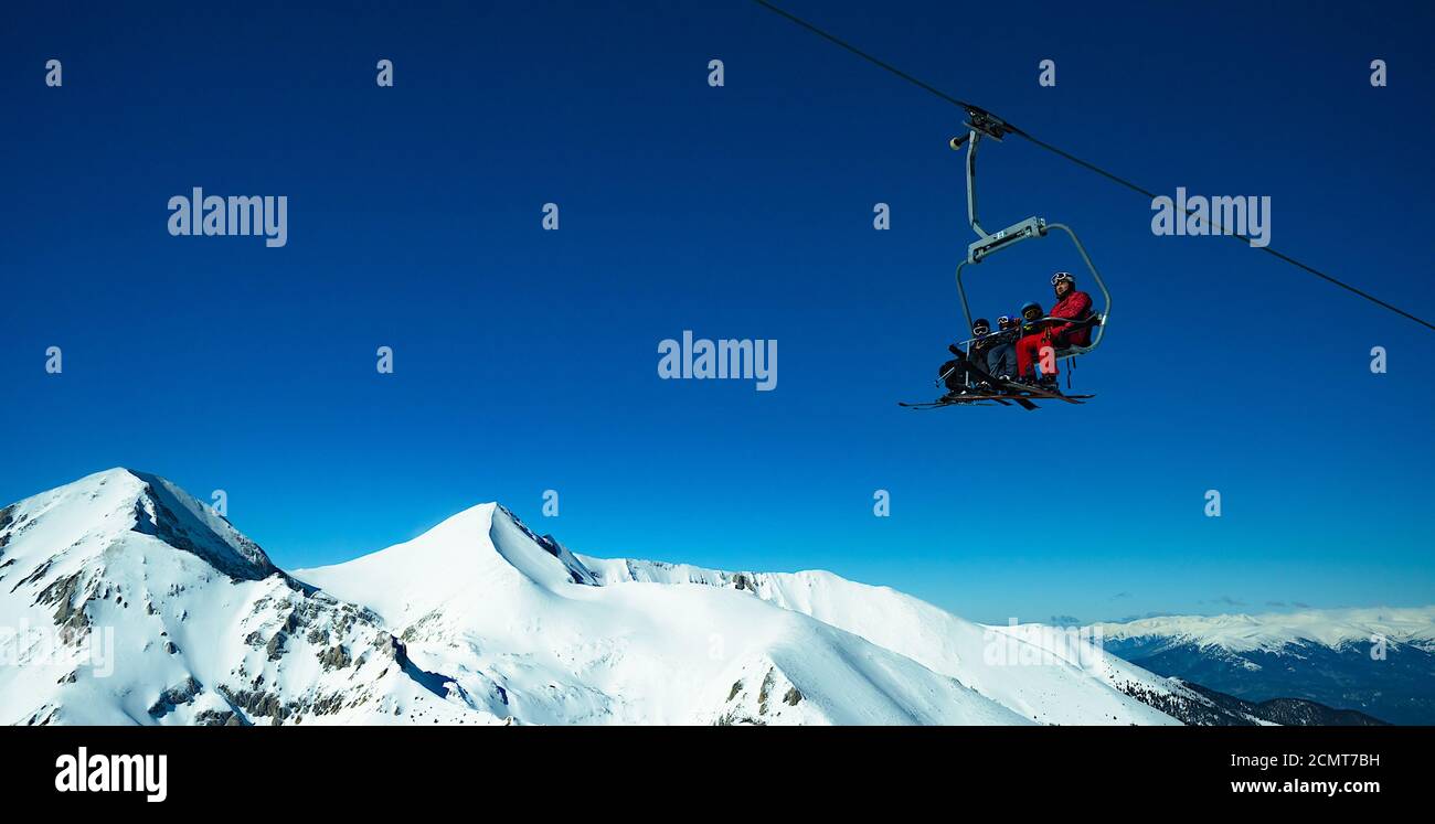 people on a ski lift in the mountains Stock Photo