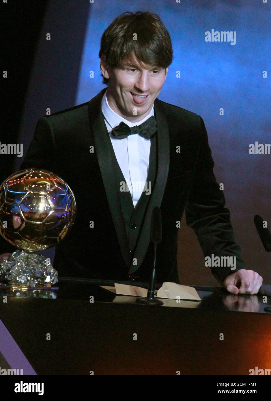 Lionel Messi of Argentina, FIFA World Player of the Year makes a speech as  he stands next to his FIFA Ballon d'Or 2010 trophy during the FIFA Ballon  d'Or 2010 soccer awards