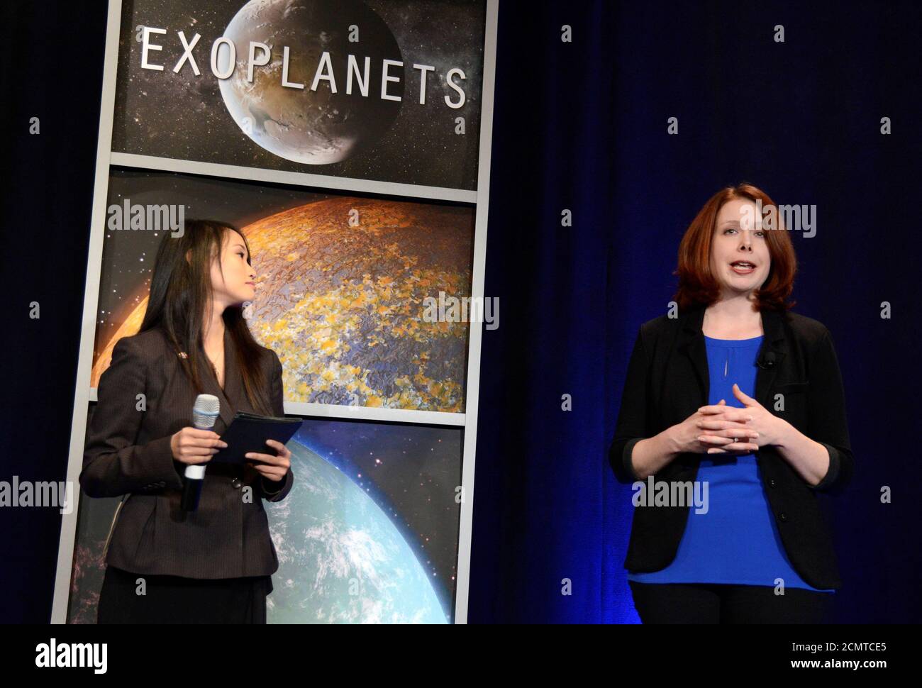 Space Telescope Science Institute astronomer Nikole Lewis (R) makes remarks as NASA Public Affairs Officer Felicia Chou listens, during a news conference to present new findings on exoplanets, planets that orbit stars other than Earth's sun, in Washington, U.S., February 22, 2017.                             REUTERS/Mike Theiler Stock Photo