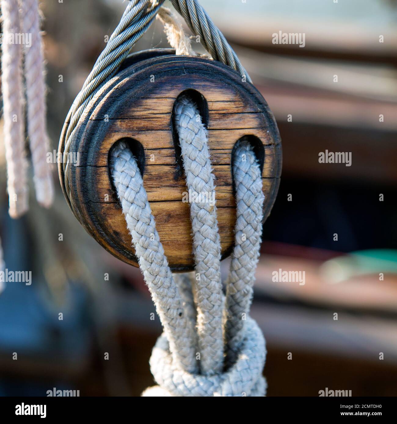 Old wooden pulley with ropes on a sailing ship Stock Photo - Alamy