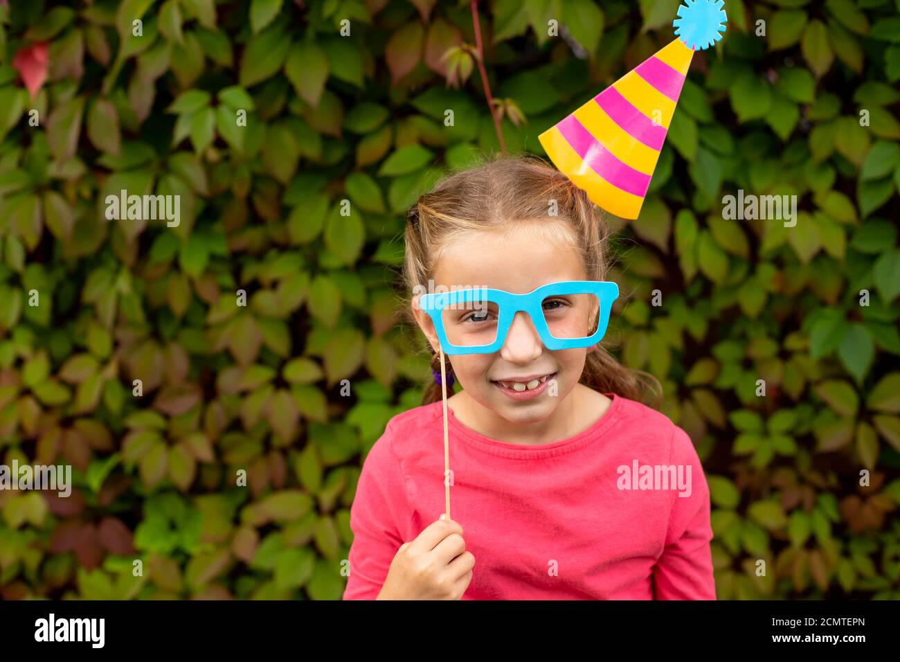 Young girl is preparing for birthday party with photo booth props. Photobooth  Birthday and Party Set and wedding.Happy child with glasses, hat, lips  Stock Photo - Alamy