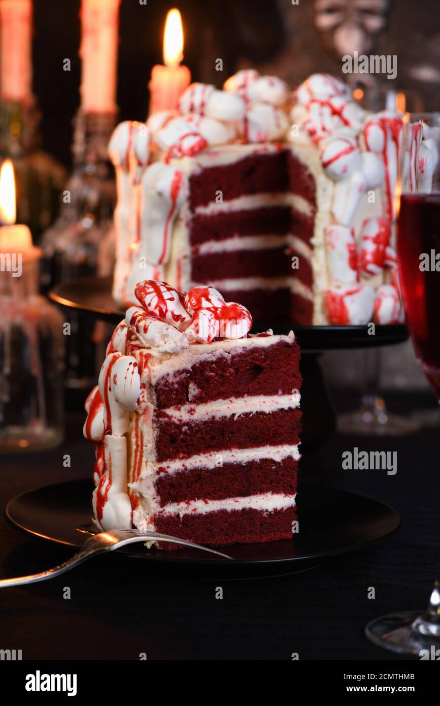 A piece of creepy cake (red velvet), decorated with meringue bones ...