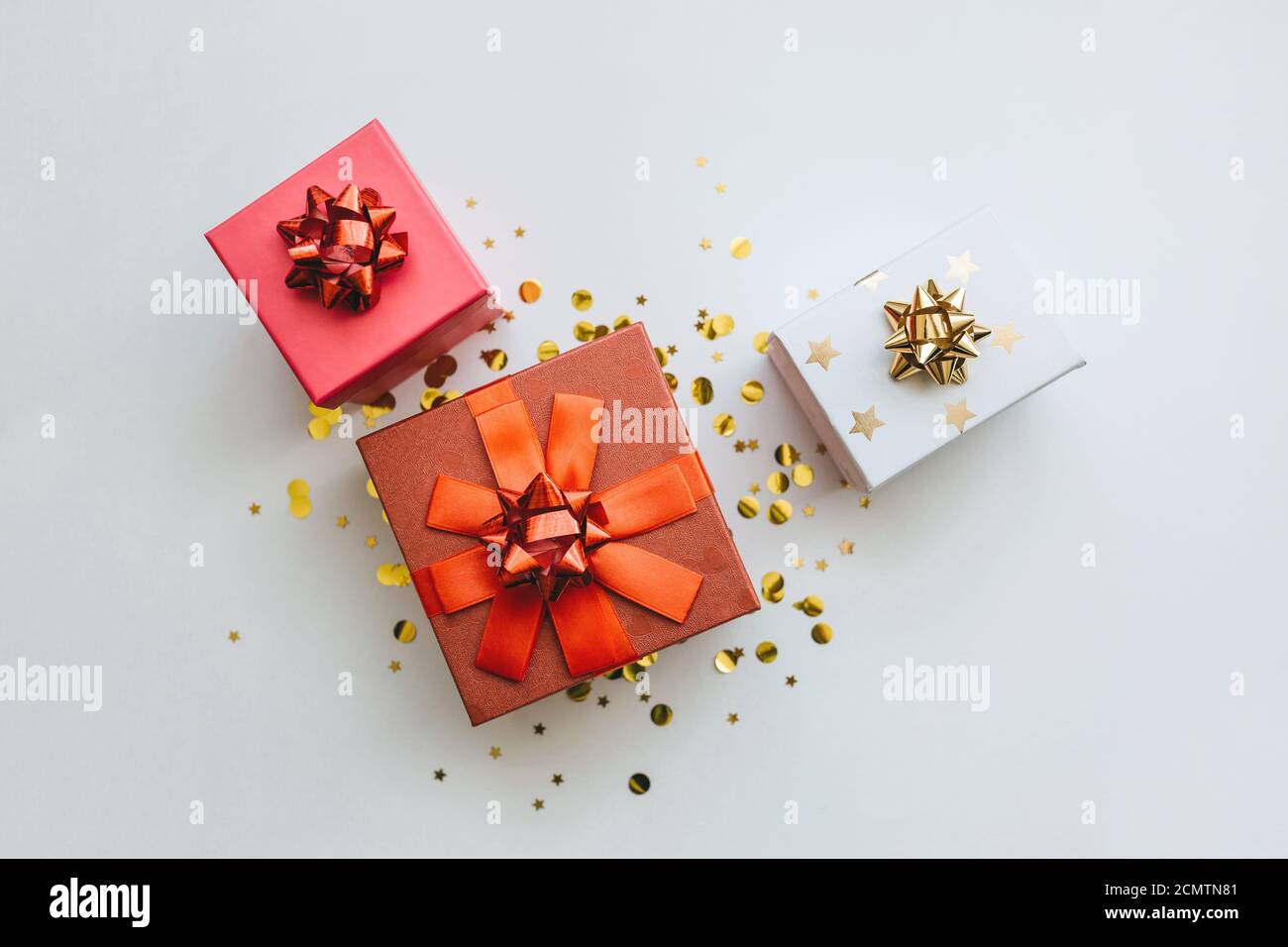 Lots of festive gift boxes on a white festive background with golden ...