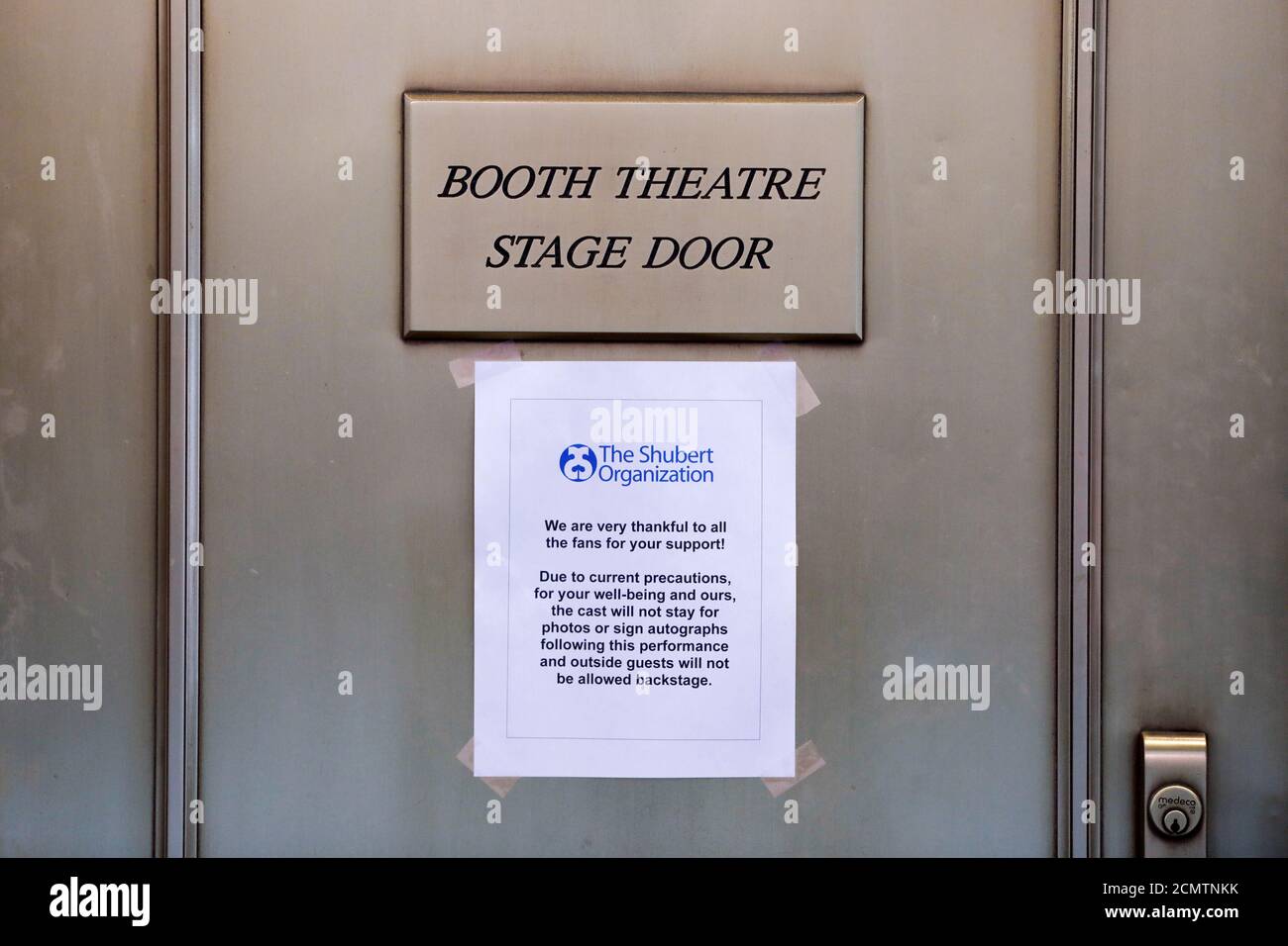 Signage regarding the coronavirus is seen on the stage door of the Booth Theatre as Broadway shows announced they will cancel performances due to the coronavirus outbreak in Manhattan, New York City, New York, U.S., March 12, 2020. REUTERS/Andrew Kelly Stock Photo