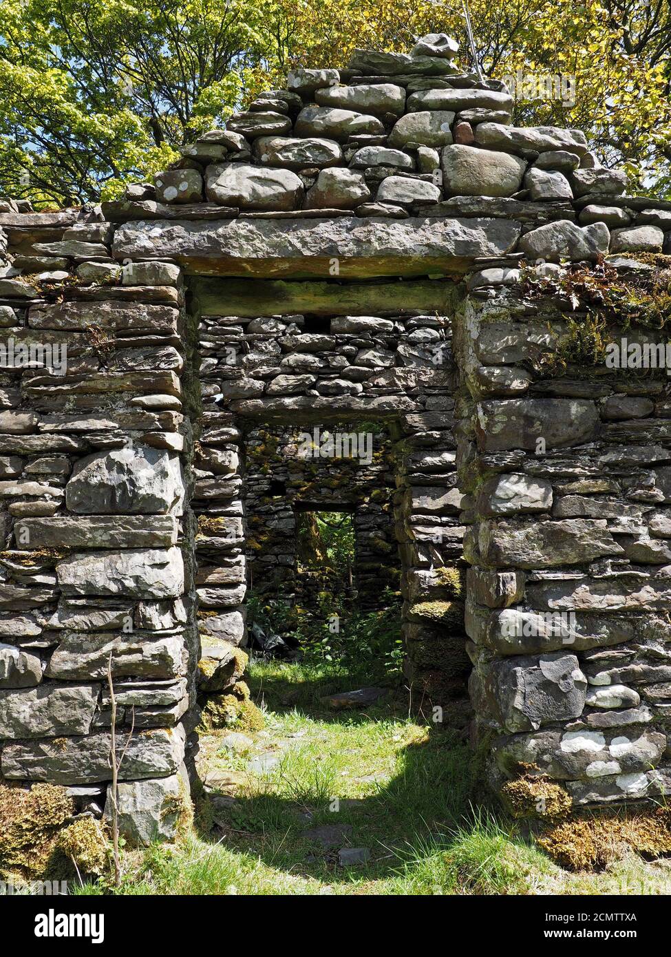 3 three receding aligned door openings in ruined and overgrown slate