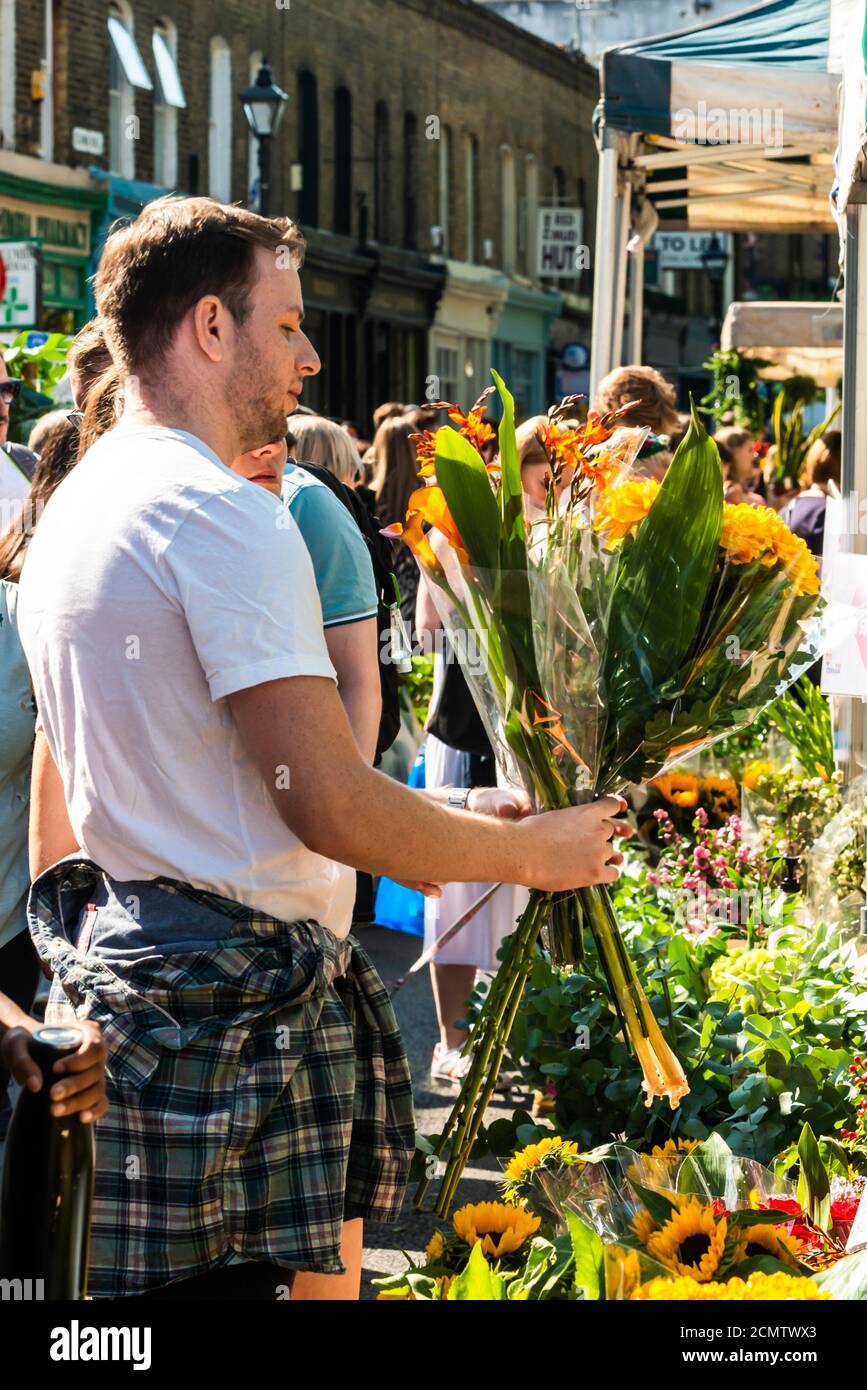 London, United Kingdom - September 13, 2020: Columbia Road Flower Sunday market. People are choosing flowers Stock Photo