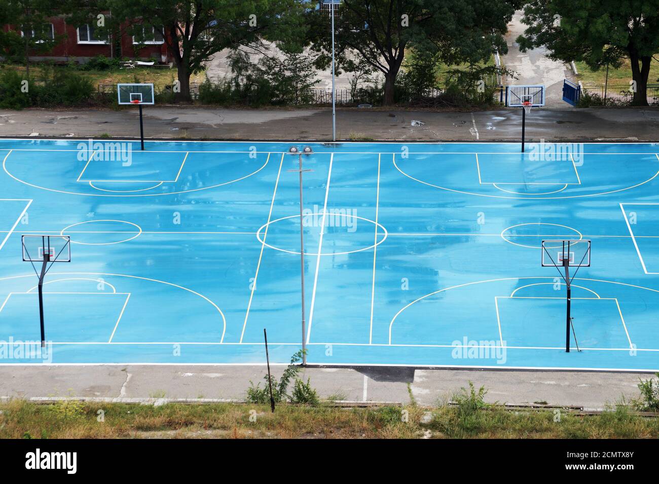basketball court wet from the rain in a residential area, top view