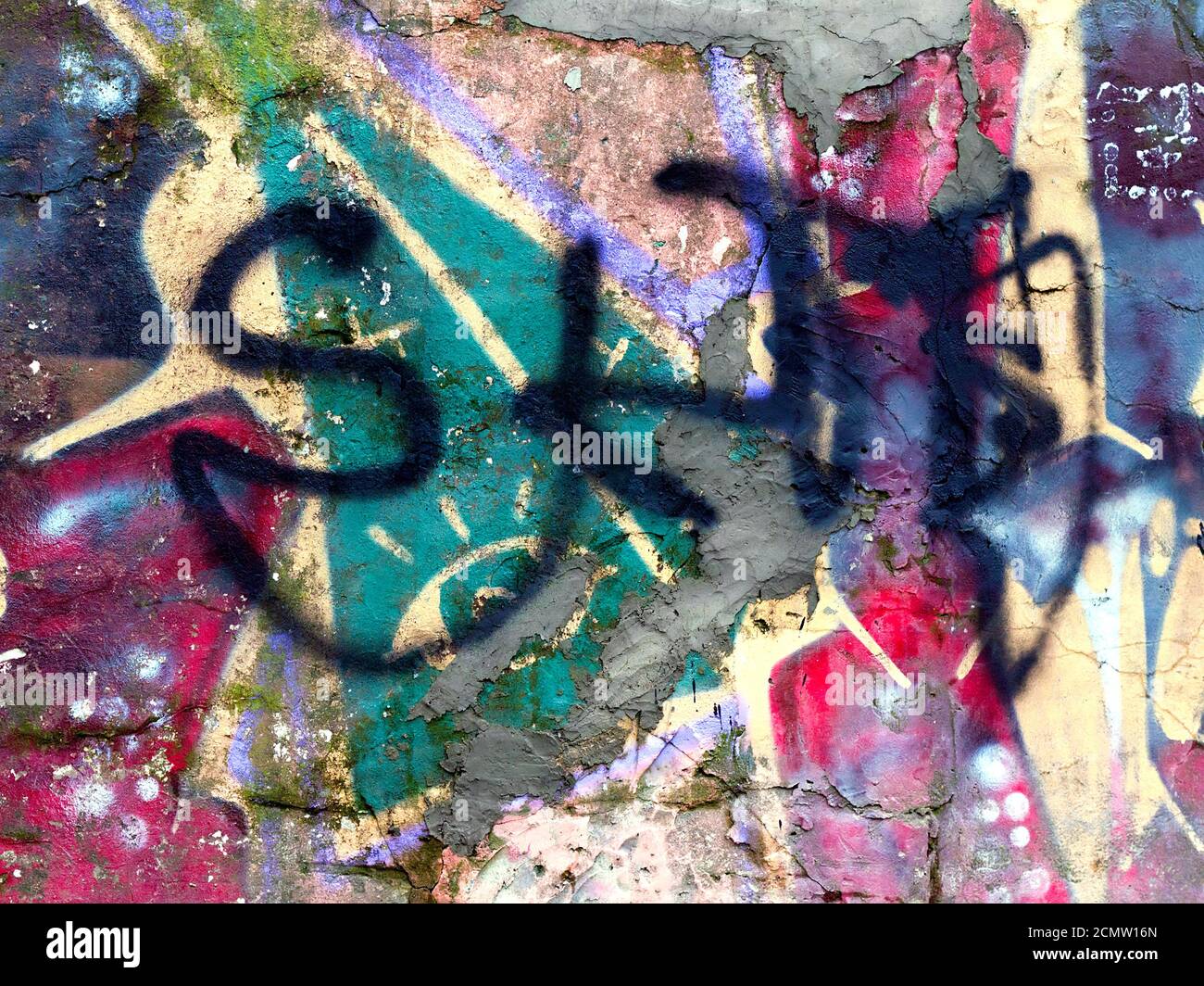 piece of graffiti images on an old brick wall as background Stock Photo