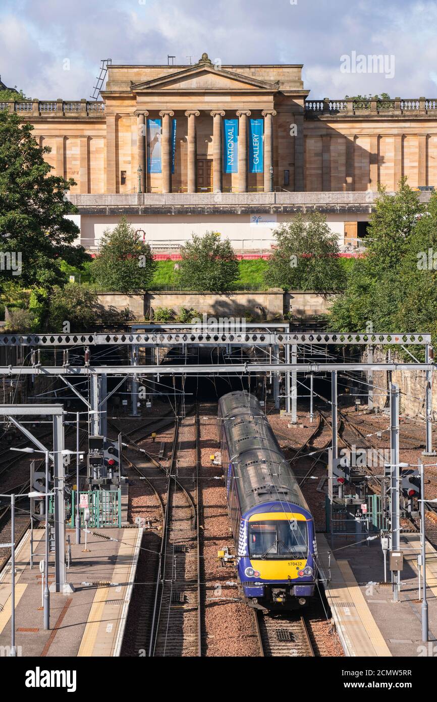 Train arriving at Waverley station after emerging from tunnel below the Scottish National Gallery Edinburgh Scotland Stock Photo