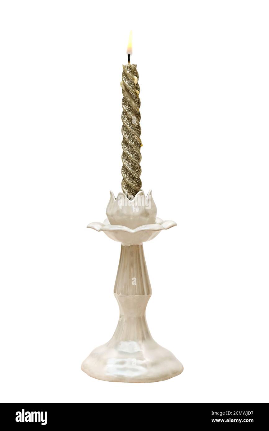 Twisted Candle with sparkles in faience candlestick isolated on white background Stock Photo
