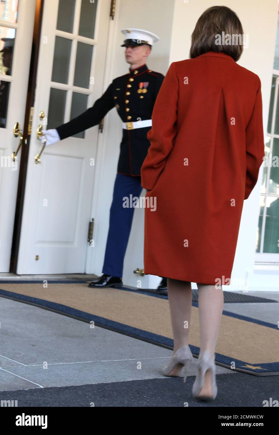 U.S. House Minority Leader Nancy Pelosi (D-CA), wearing a red coat by Max  Mara, departs after speaking to reporters following a meeting with  President Donald Trump at the White House in Washington,