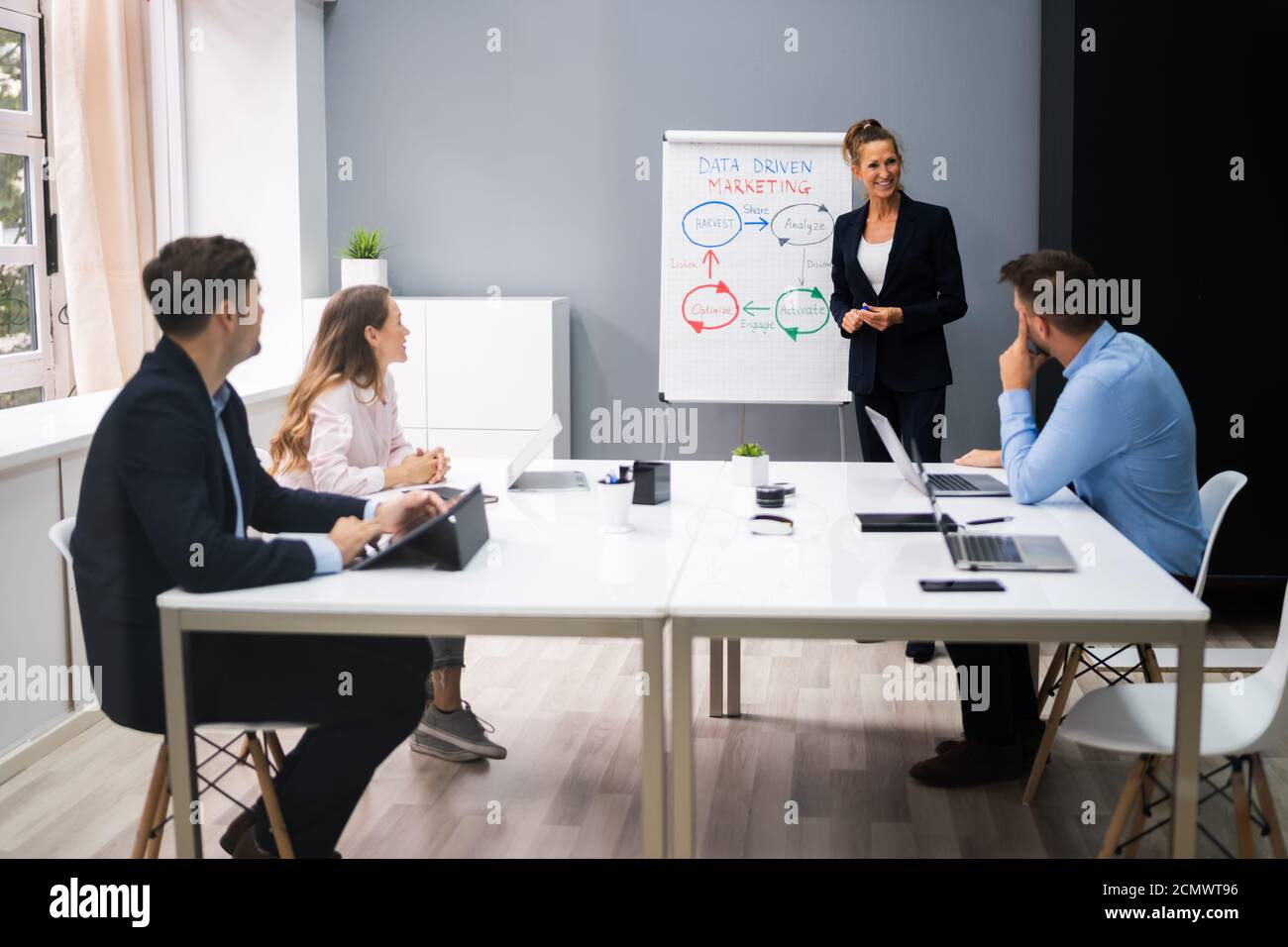 Giving Business Presentation Speech At Board Meeting Stock Photo